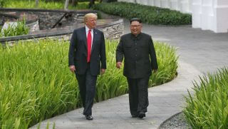 SINGAPORE, SINGAPORE - JUNE 12: In this handout photograph provided by The Strait Times, U.S. President Donald Trump (L) with North Korean leader Kim Jong-un (R) with during their historic U.S.-DPRK summit at the Capella Hotel on Sentosa island on June 12, 2018 in Singapore. U.S. President Trump and North Korean leader Kim Jong-un held the historic meeting between leaders of both countries on Tuesday morning in Singapore, carrying hopes to end decades of hostility and the threat of North Korea's nuclear programme.