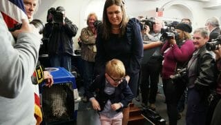 White House Press Secretary Sarah Huckabee Sanders carries her son, four-year-old Huck