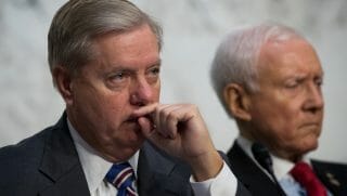 Sens. Lindsey Graham, left, and Orrin Hatch, right, listen to testimony in front of the Senate Judiciary Committee.