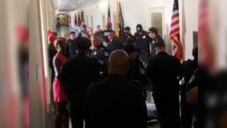 Capitol police officers arrive on the scene after protesters try to force their way into Rep. Andy Harris' office.