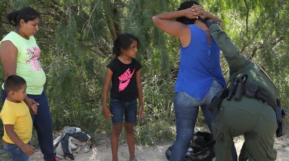 Central American asylum seekers are taken into custody by U.S. Border Patrol agents on June 12, 2018, near McAllen, Texas.