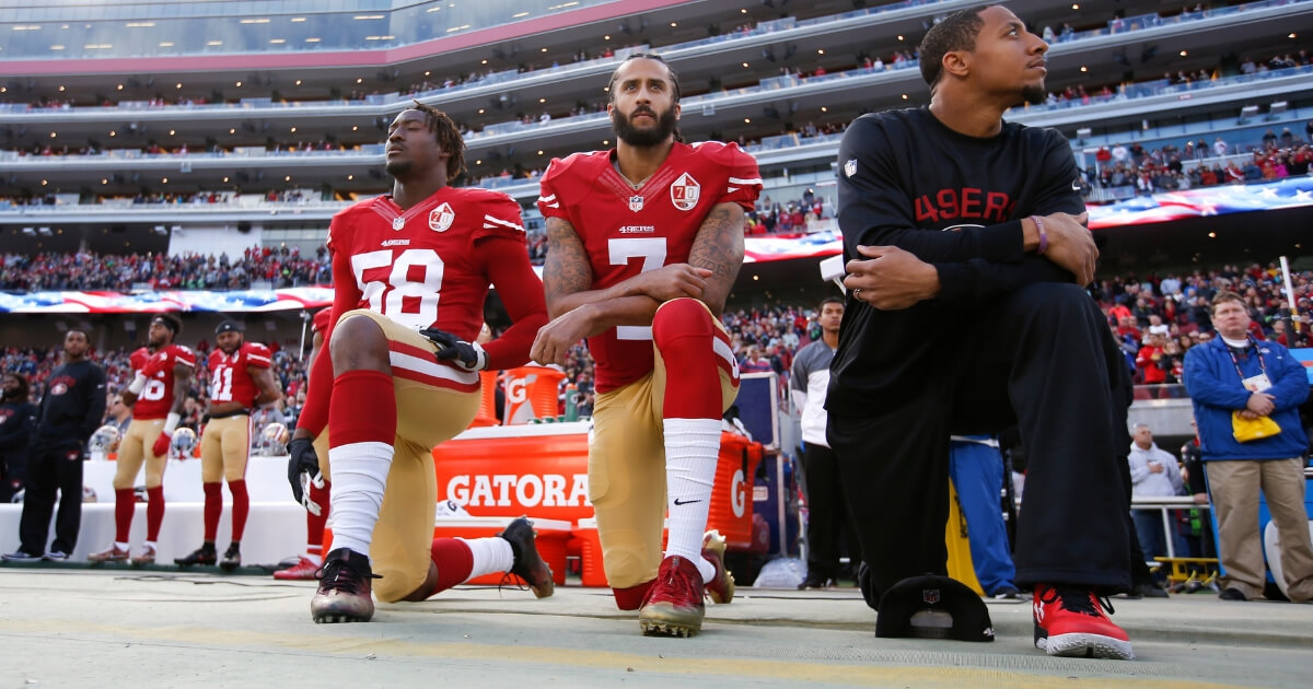 Eli Harold #58, Colin Kaepernick #7 and Eric Reid #35 of the San Francisco 49ers kneel on the sideline, during the anthem, prior to the game against the Seattle Seahawks at Levi Stadium on Jan. 1, 2017.