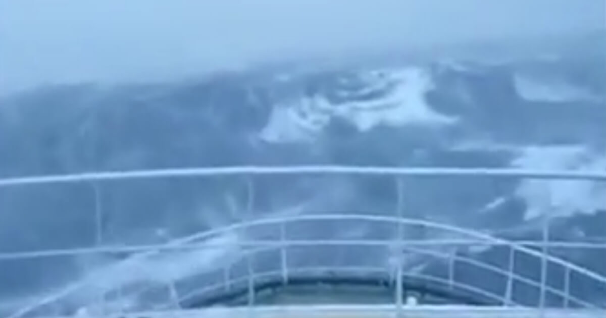 Ship cruises through wave