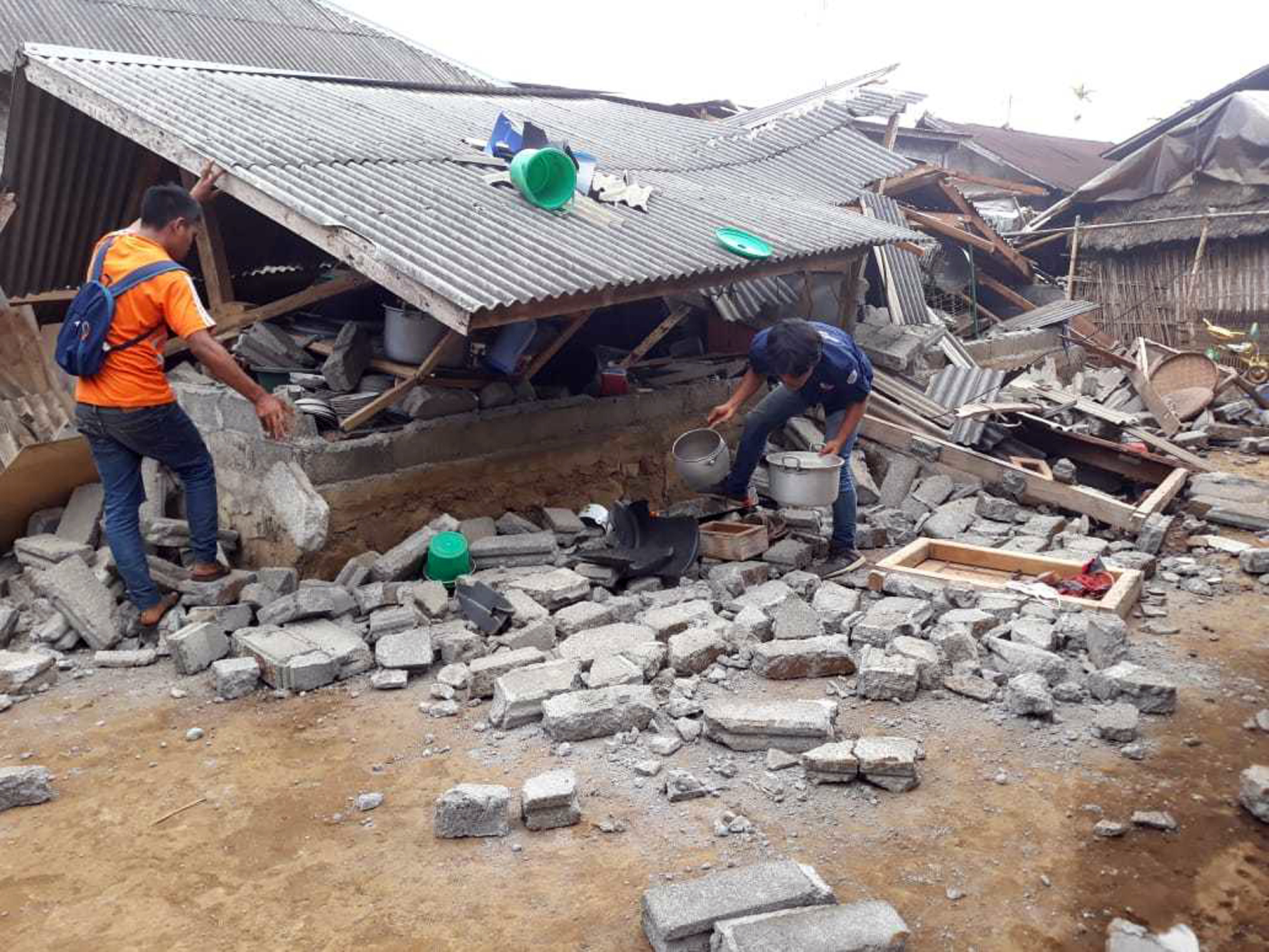 Villagers clear debris caused by an earthquake at Sajang village, Sembalun, East Lombok, Indonesia, Monday, July 30, 2018. A strong and shallow earthquake early Sunday killed more than a dozen people on Indonesia's Lombok island, a popular tourist destination next to Bali, officials said.