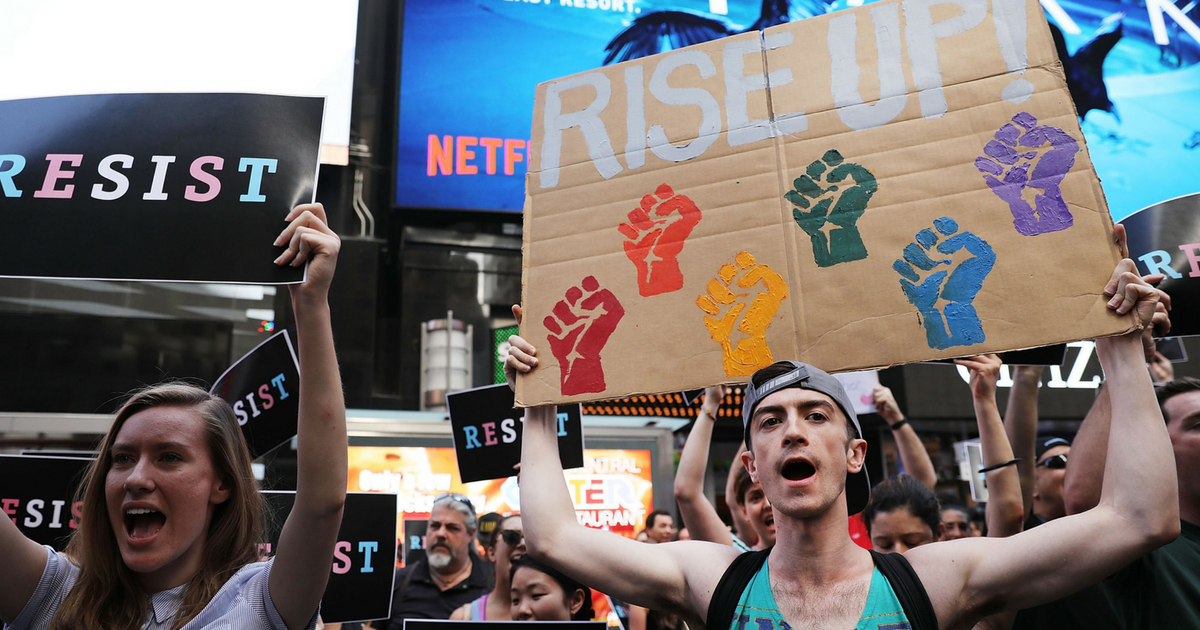 Dozens of protesters gather in Times Square near a military recruitment center to show their anger at President Donald Trump's decision to reinstate a ban on transgender individuals from serving in the military on July 26, 2017 in New York City. Trump citied the 'tremendous medical costs and disruption' for his decision.