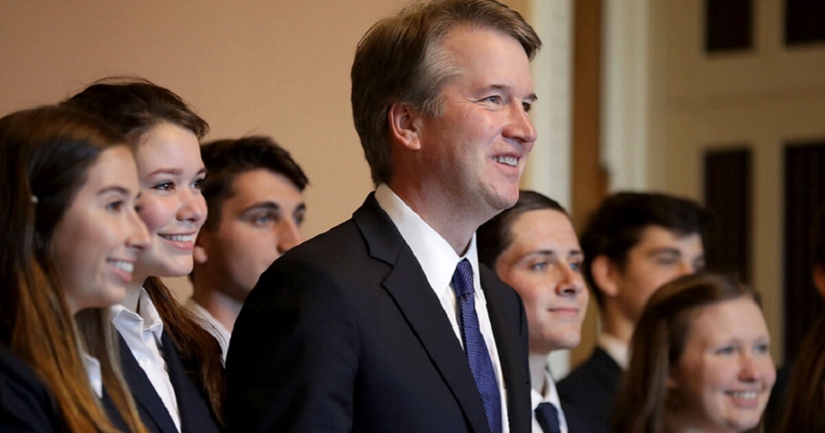 Brett Kavanaugh surrounded by young people.