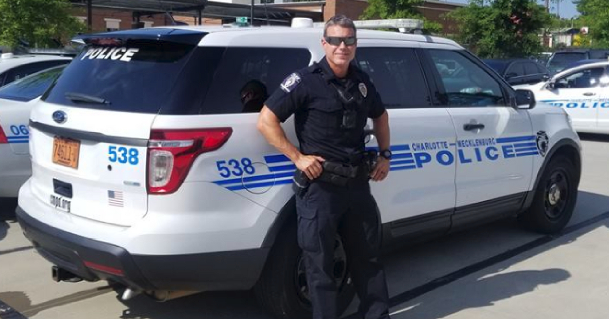 CMPD Officer Leans on Car