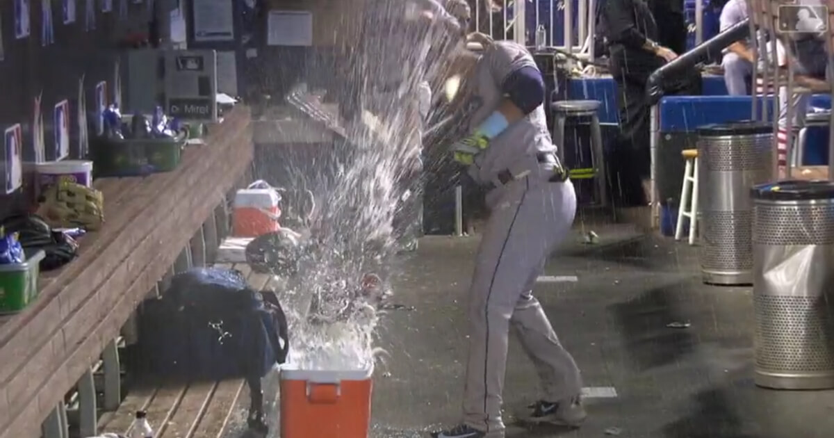 After striking out in the 2nd inning, Tampa Bay's Carlos Gomez vents his frustration by hitting the water coolers in the dugout.