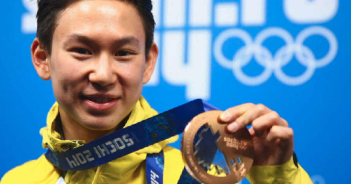 Men's figure skater Dennis Ten poses with his bronze medal at the 2014 Winter Olympics