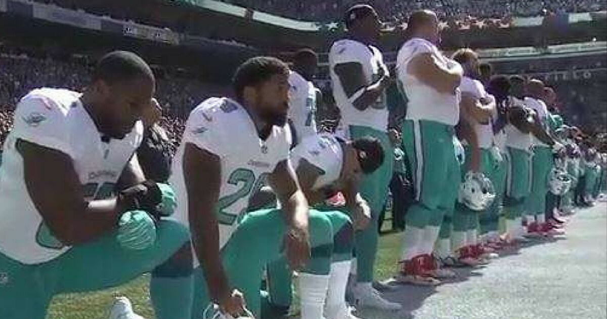 Miami Dolphins players kneel during the national anthem before a 2017 game