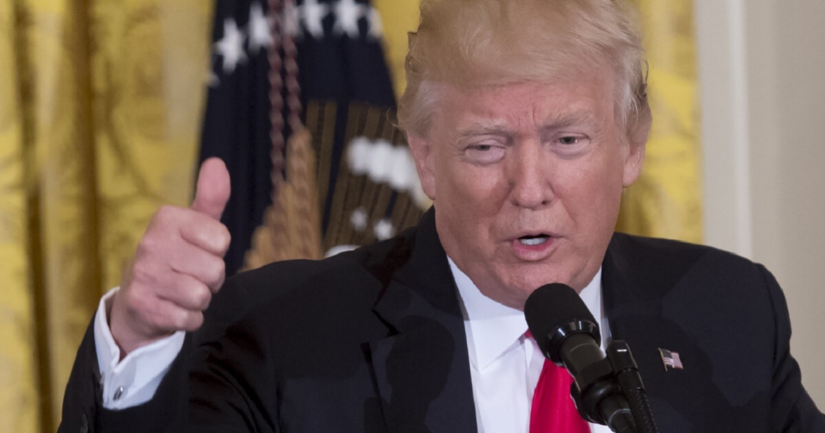 Donald Trump giving a thumb's up sign.