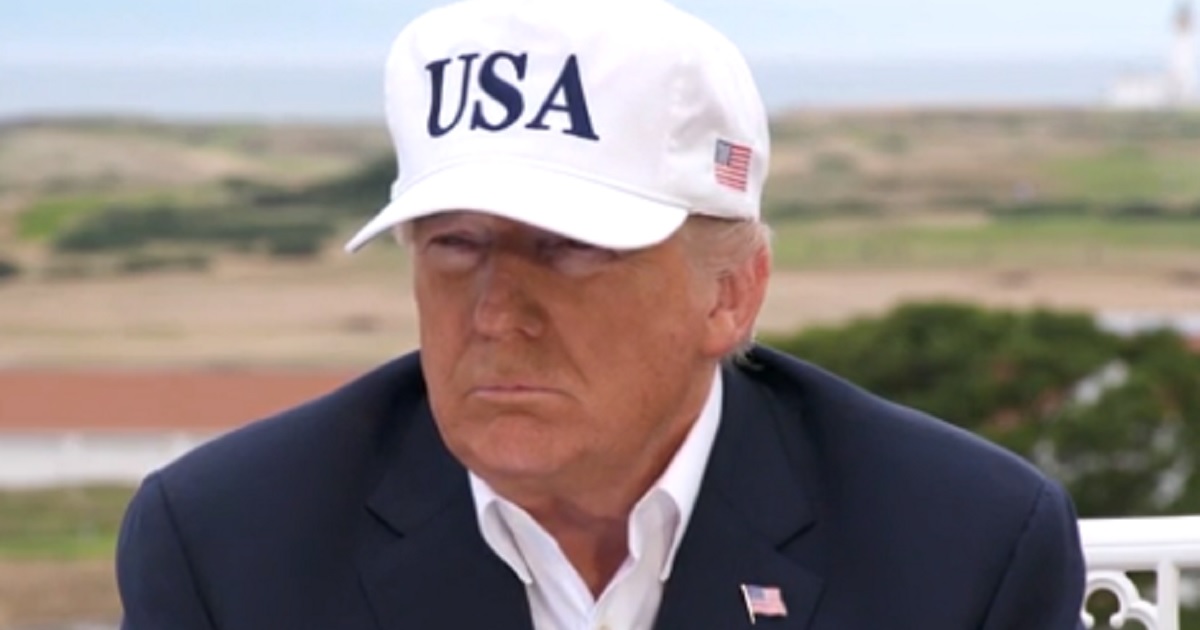 President Trump wearing a ball cap with "USA" emblazoned on it.