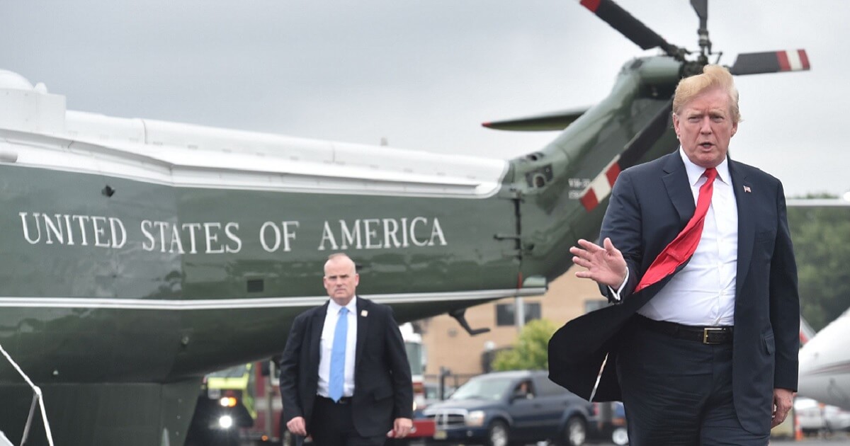 President Trump gestures to the camera after leaving the Marine One helicopter.