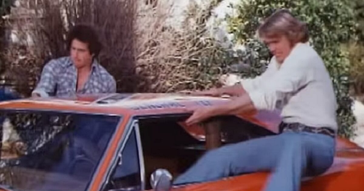 Beau and Luke Duke leap into their car in the old "Dukes of Hazzard" show.