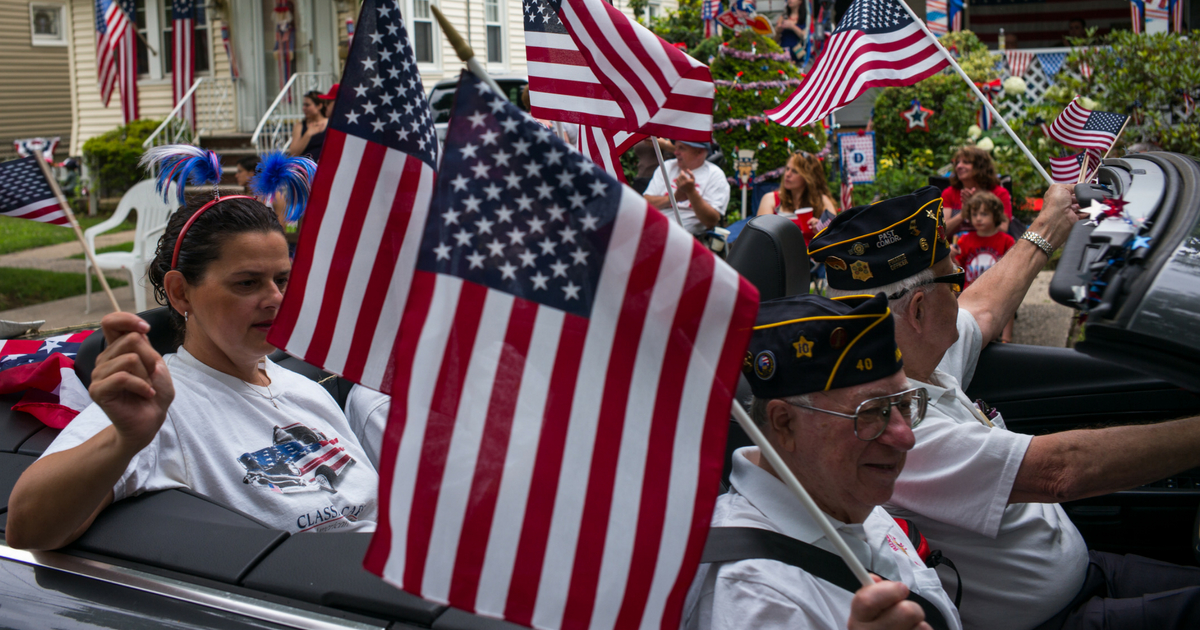 U.S. veterans of foreign wars drive past local residents July 4, 2014 in the Independence Day parade in Ridgefield Park, New Jersey. Ridgefield Park has the oldest Fourth of July parade in New Jersey. The United States marks 238 years as an independent nation as it celebrates the national holiday.