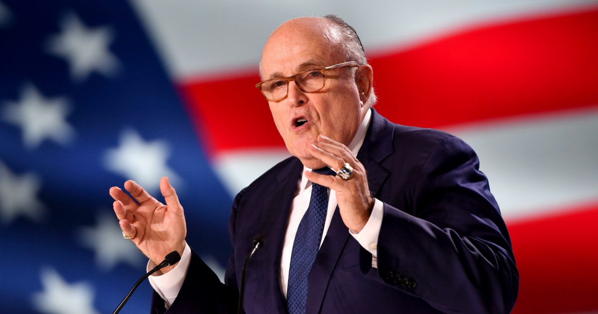 Giuliani in front of an American flag