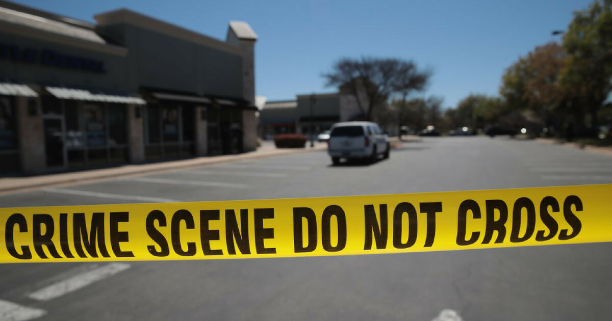 Crime scene tape blocks access to the public as FBI agents collect evidence at a FedEx Office facility following an explosion at a nearby sorting center on March 20, 2018 in Sunset Valley, Texas.