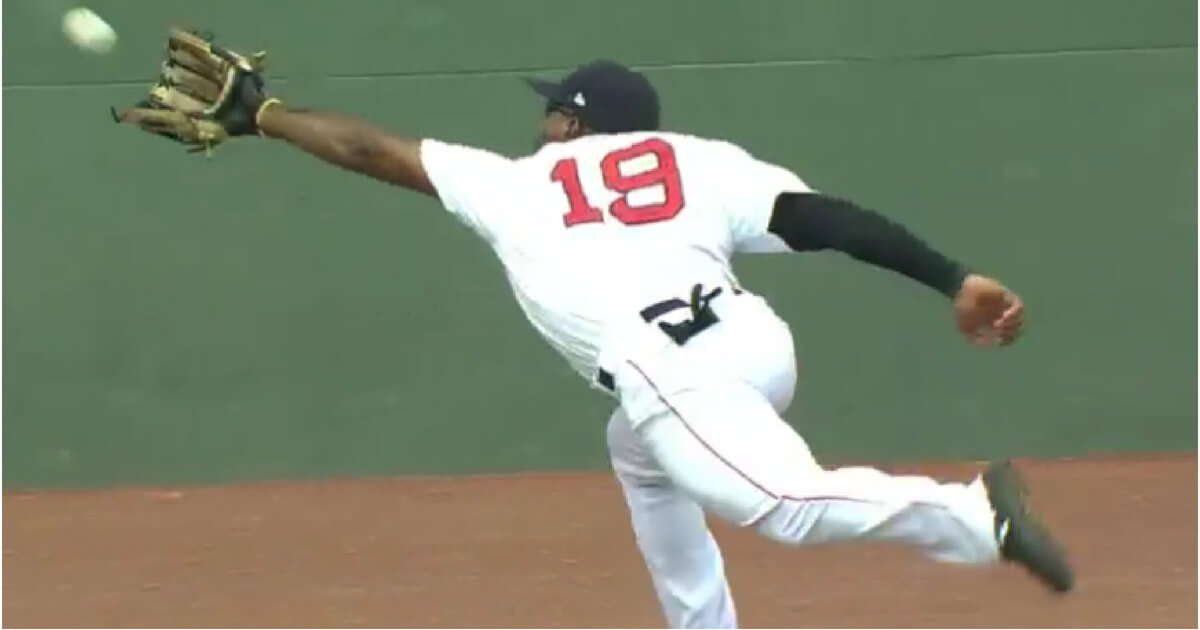 Boston's Jackie Bradley Jr. makes a diving catch and rolls into the wall at Fenway Park