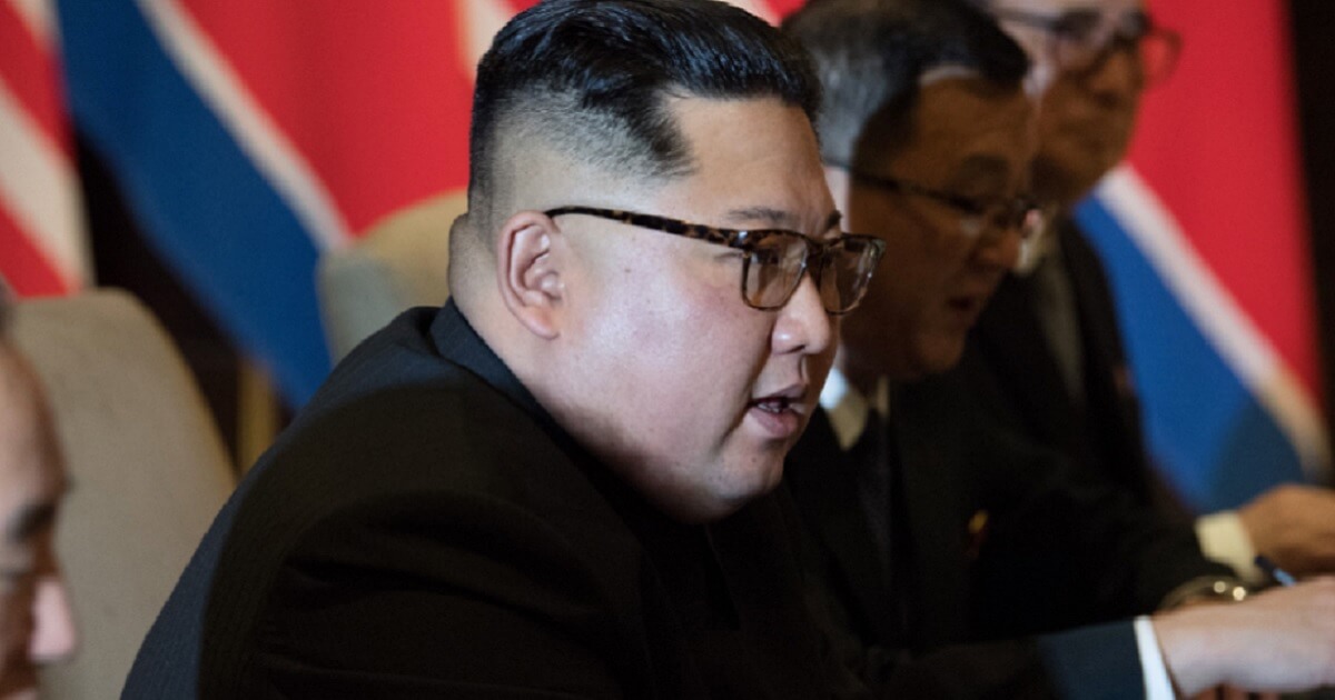 Kim Jong Un seated at a table.