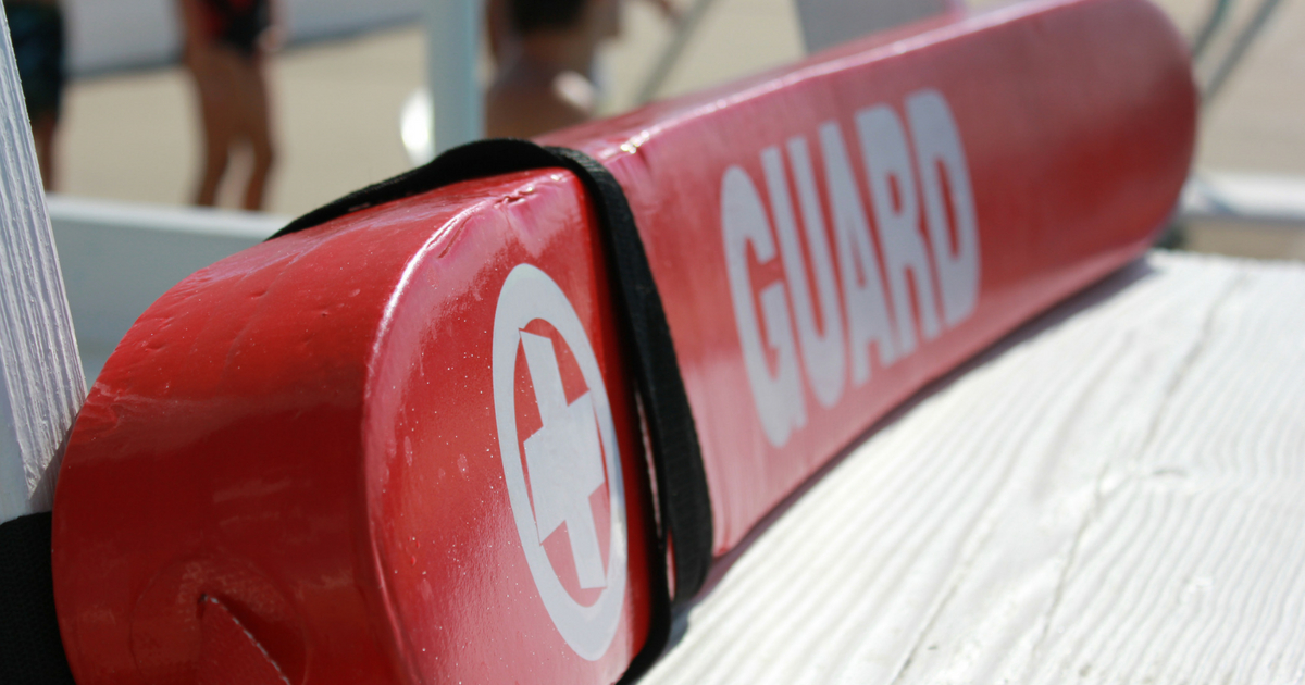 Lifeguard rescue tube on lifeguard pool stand.