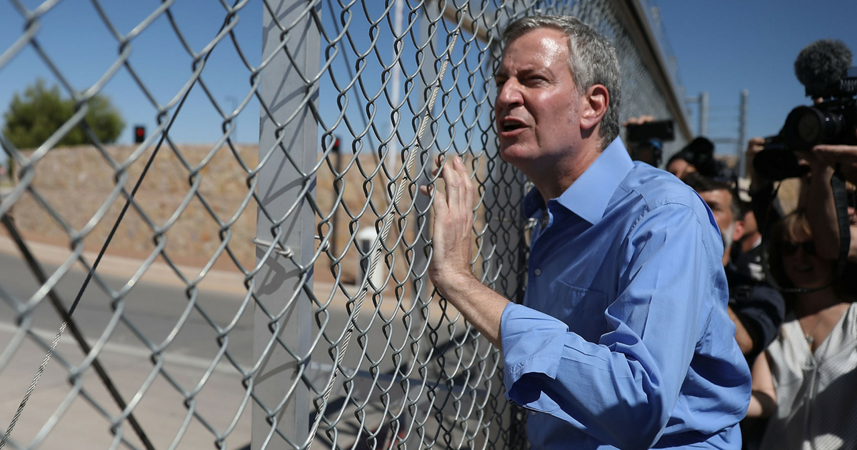 New York City Mayor Bill de Blasio stops at a gate after being told he could not cross through the gate to the tent facility setup at the Tornillo-Guadalupe Port of Entry as he joins with other mayors from the U.S. Conference of Mayors to call for the immediate reunification of separated immigrant families on June 21, 2018 in Fabens, Texas.