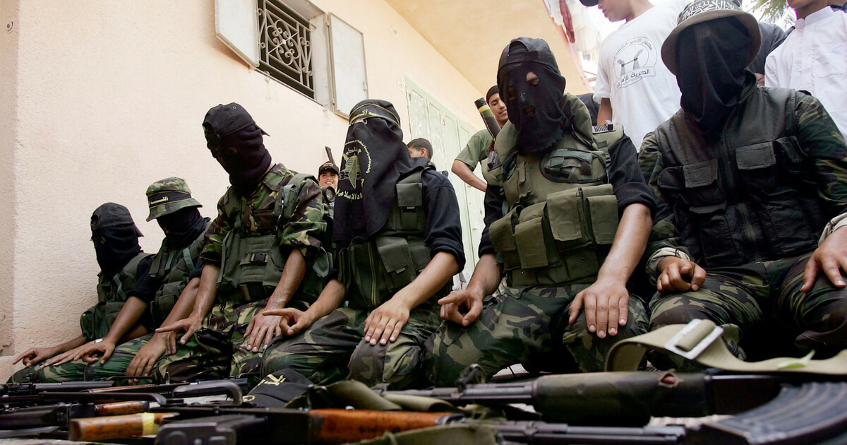 a group of muslim extremists sit on the floor