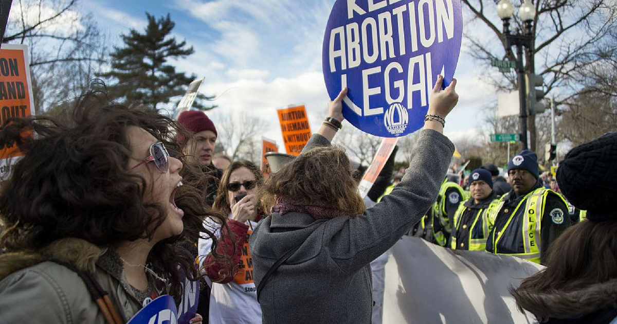 Pro-choice activists block the road against US Capitol Police, who are escorting the March For Life's path, in front of the US Supreme Court in Washington, DC, January 22, 2015.