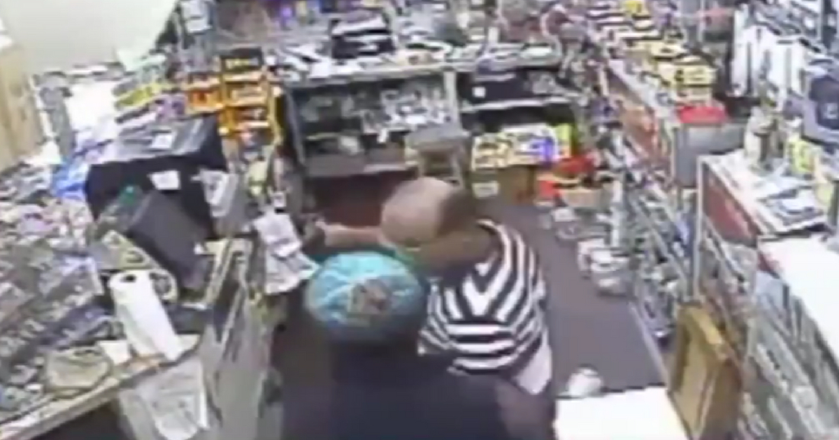 An armed robber takes cash from a convenience store in Florida.