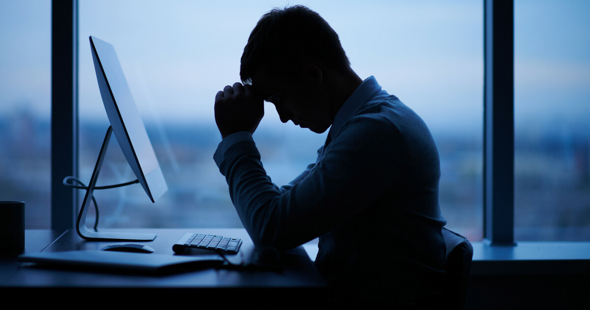 Man praying at computer