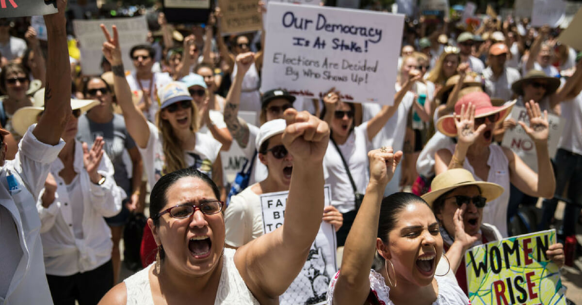 Demonstrators rally against the Trump administration's immigration policies outside of the Texas Capitol in Austin, Texas, on June 30, 2018