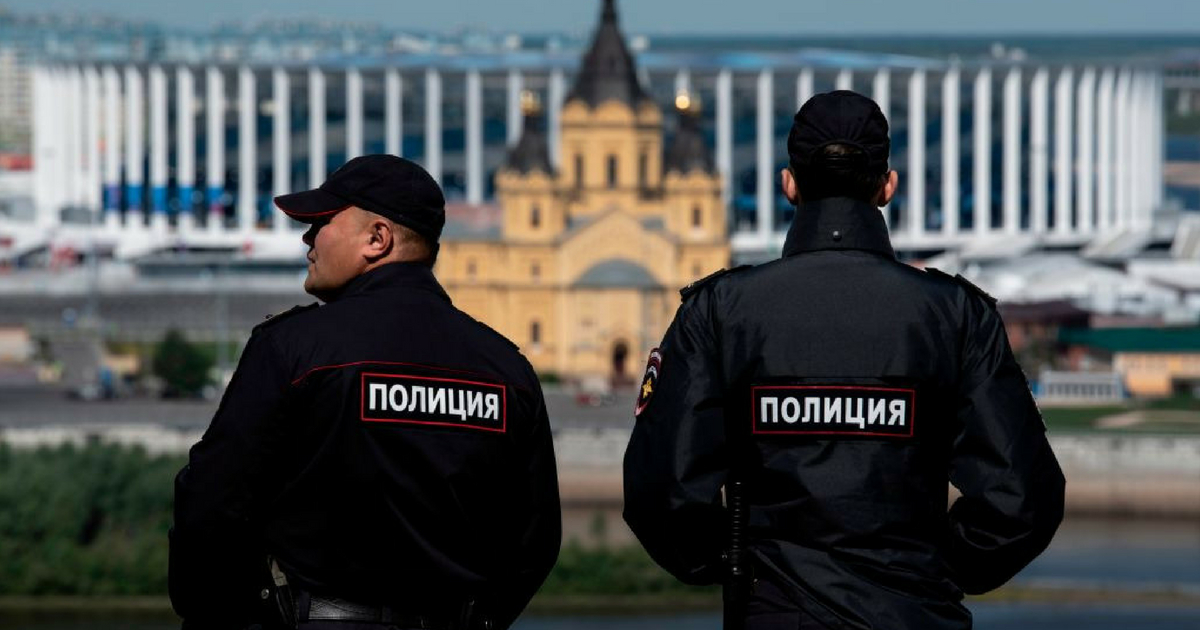 Policemen stand guard overlooking the Nizhny Novgorod stadium situated behind the cathedral of Alexandr Nevskiy in the city of Nizhny Novgorod during the Russia 2018 World Cup football tournament on June 16, 2018.