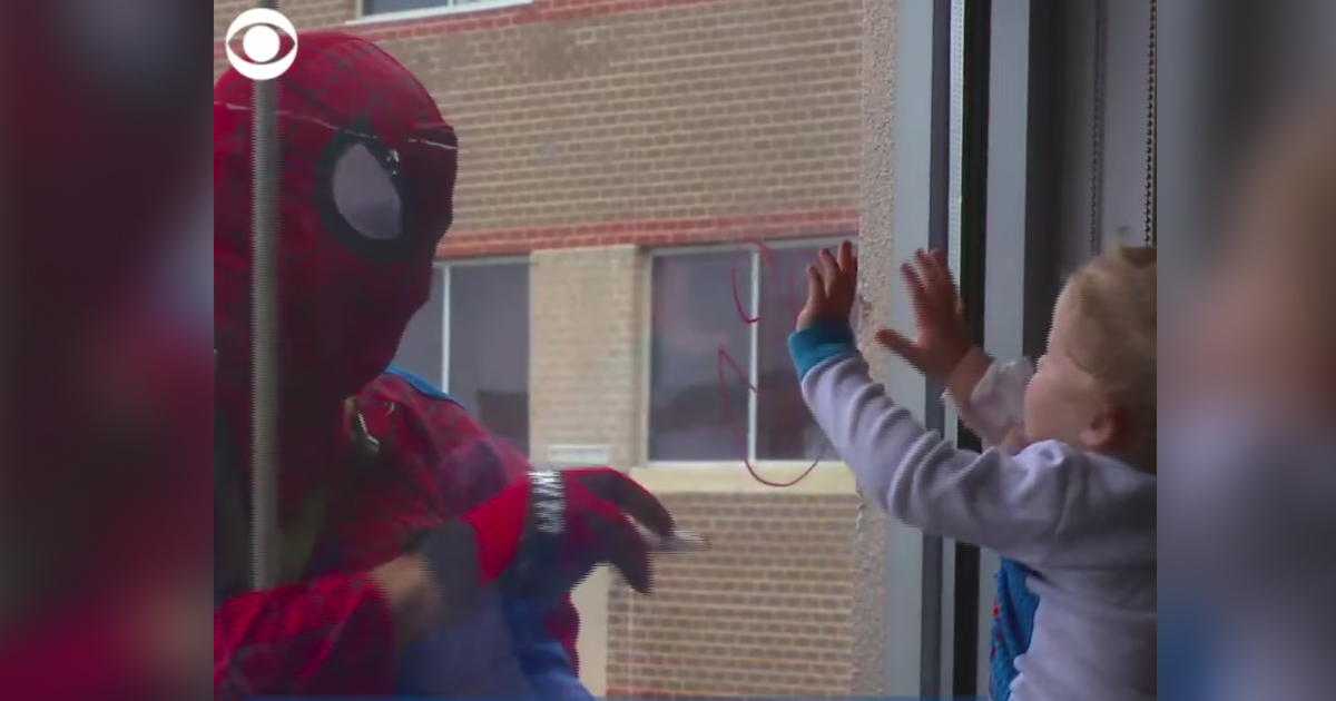 Window washers dressed as superheros for children's hospital.