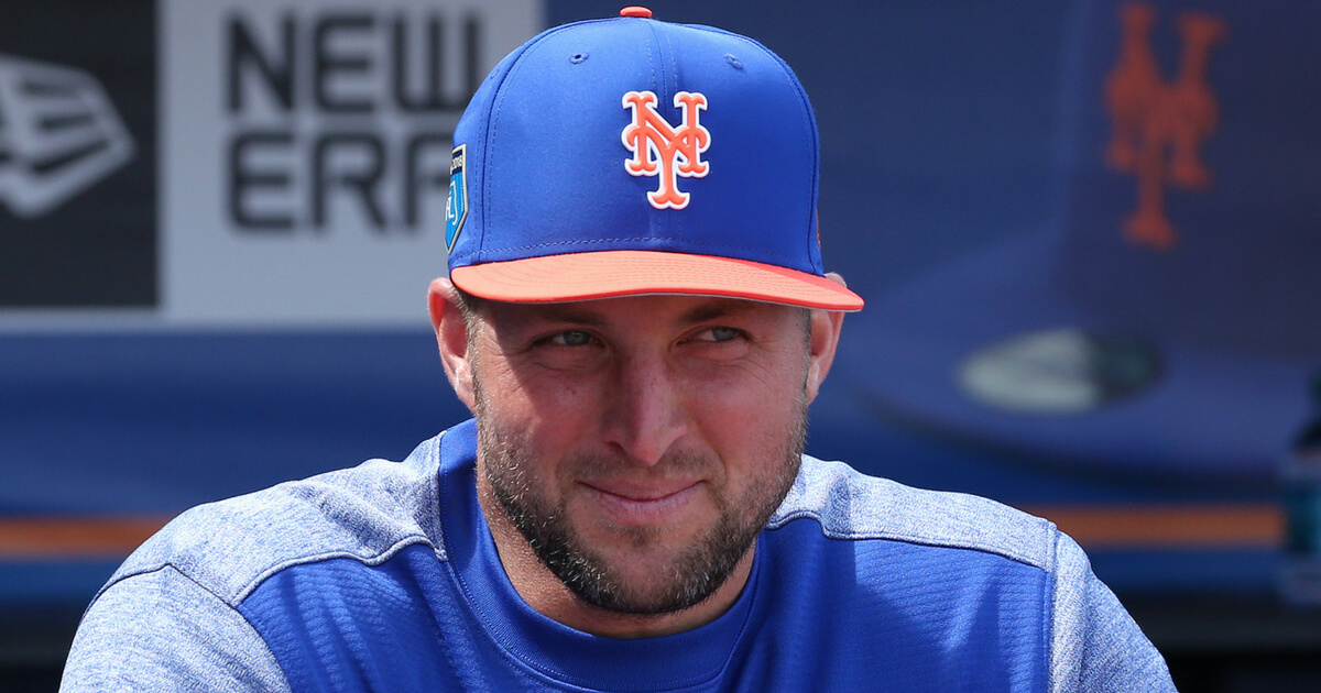 Tim Tebow #83 of the New York Mets look on from the dugout prior to the spring training game against the New York Yankees at First Date Field on March 7, 2018 in Port St. Lucie, Florida. The Yankees defeated the Mets 11-4.