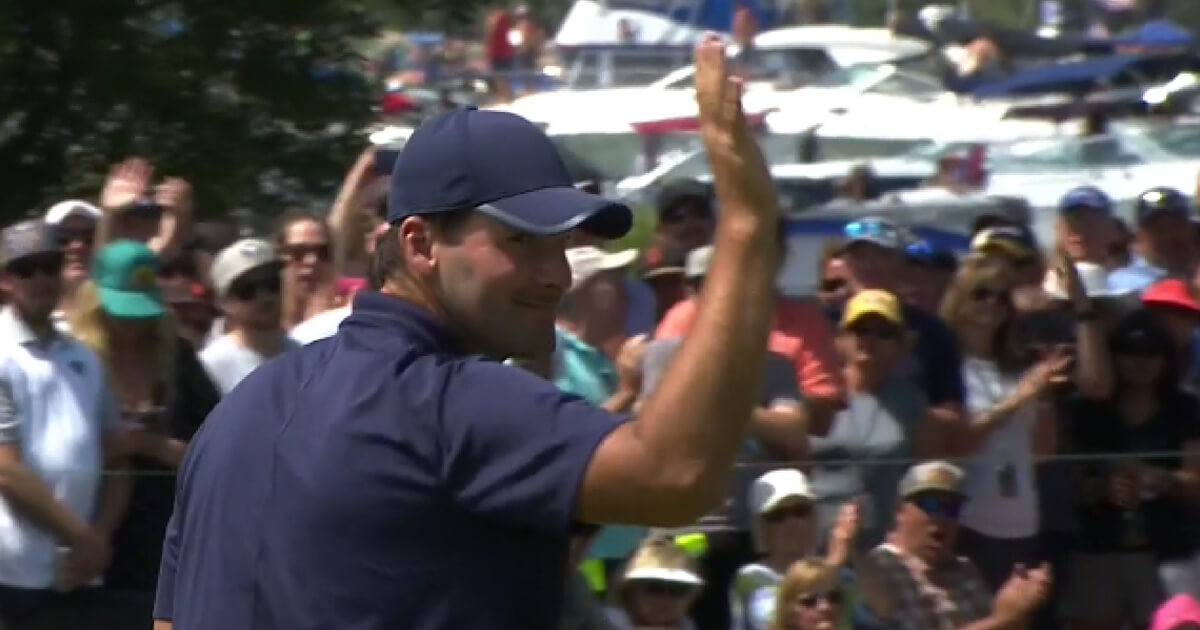 Tony Romo waves to the crowd as he walks off the 18th green and winning the 2018 American Century Championship golf tournament