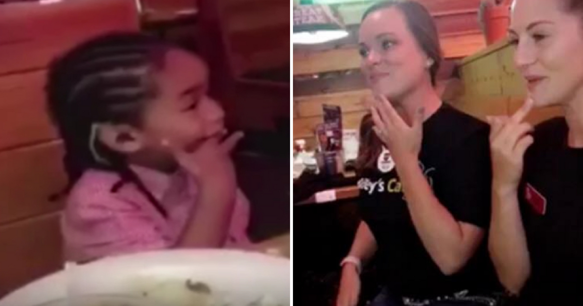 Two waitresses sign 'Happy Birthday' to a 4-year-old boy.