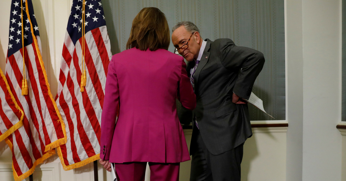 Senate Minority Leader Chuck Schumer speaks to House Minority Leader Nancy Pelosi during a news conference at the U.S. Capitol