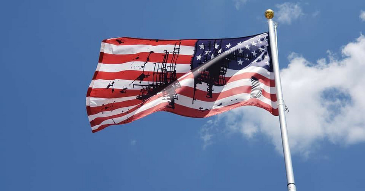 A defaced American flag is flown.