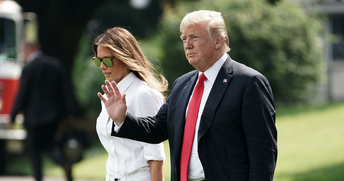 U.S. President Donald Trump (R) walks with first lady Melania Trump (L) towards Marine One on the South Lawn