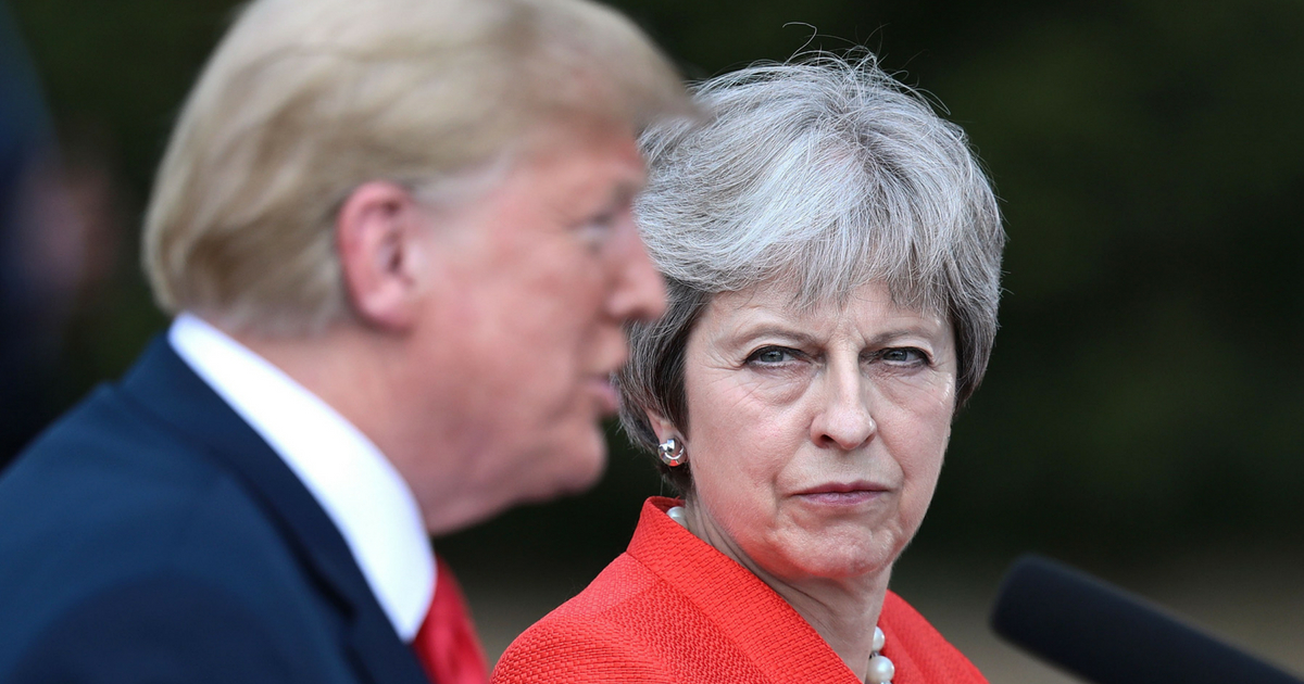 British PM Theresa May stares at Donald Trump as he speaks