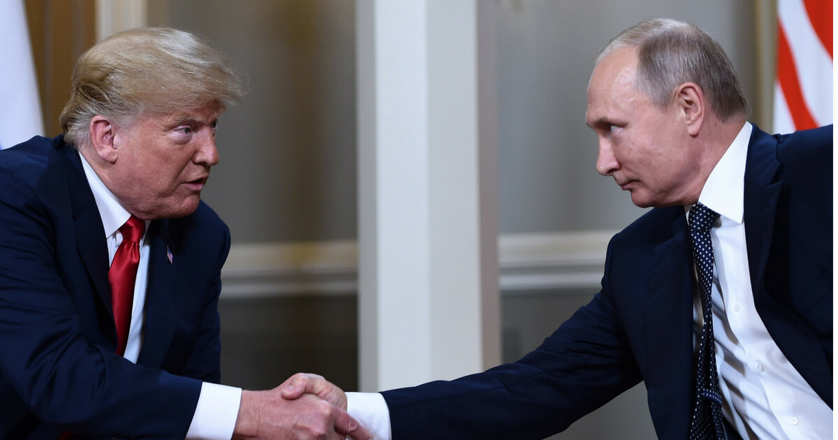 Russian President Vladimir Putin (R) and US President Donald Trump shake hands before a meeting in Helsinki, on July 16, 2018
