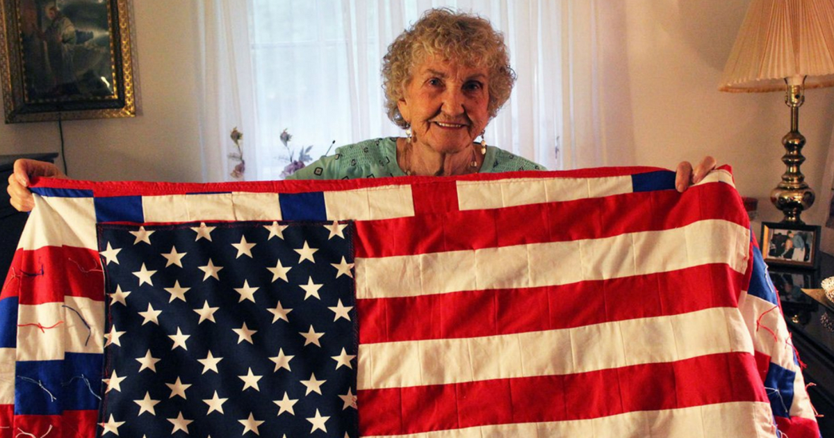 Elderly woman with flag quilt