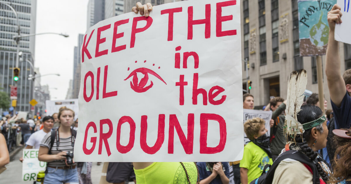 New York, USA - 21 September 2014. Woman carries a placard stating 'Keep the Oil in the Ground' whilst demonstrating for environmental awareness during the 2014 People's Climate March, New York, USA.