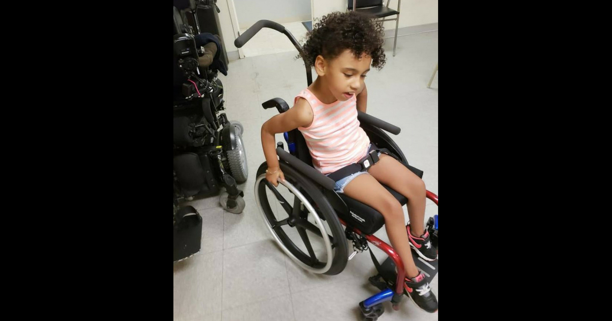 Little girl in wheelchair.