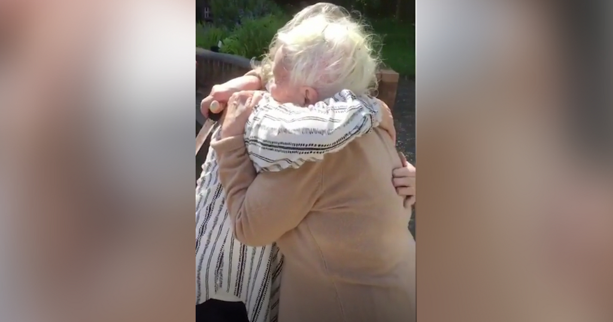 Sisters with Alzheimer's hug as they are reunited.