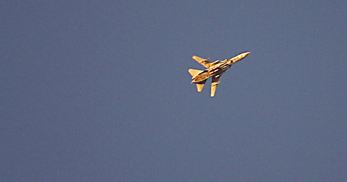 A fighter jet flies over rebel-held areas of the city of Saida