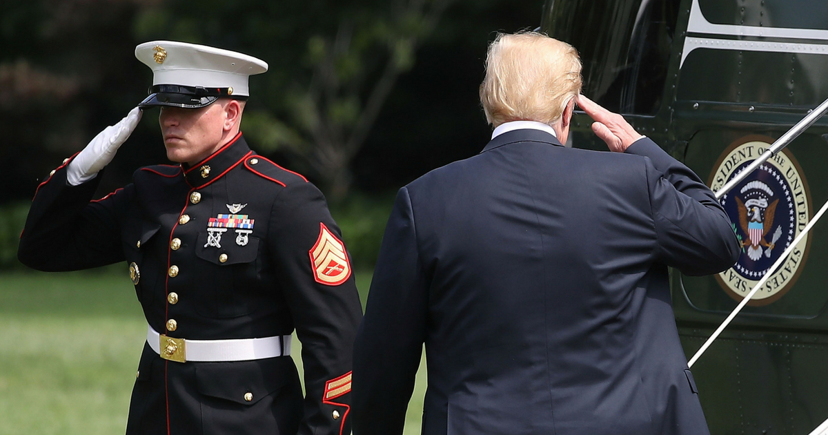 resident Donald Trump salutes to a U.S. Marine as he boards Marine One