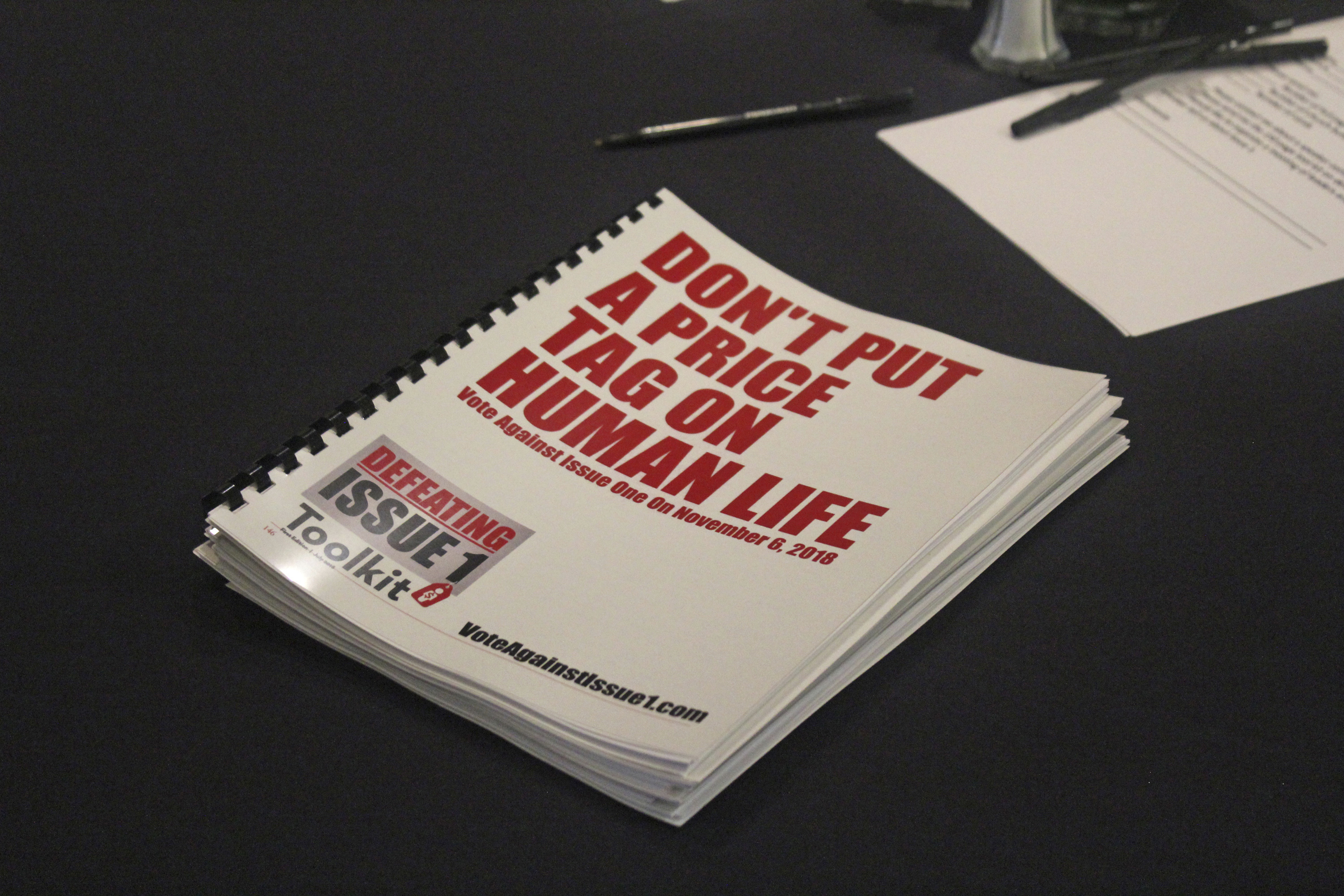 In this July 26, 2018 photo, an information booklet about a "tort reform" measure appearing on Arkansas' ballot sits on a table at a breakfast meeting of pastors in Little Rock, Arkansas. The Family Council Action Committee, a conservative Christian group, is rallying churches against the ballot measure to impose new limits on lawsuit damages.