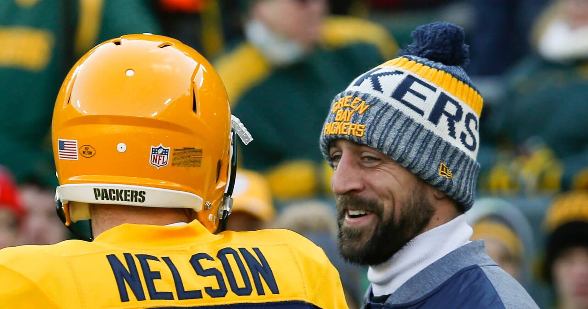 In this Nov. 19, 2017, file photo, Green Bay Packers quarterback Aaron Rodgers talks to Jordy Nelson before a game in Green Bay, Wisconsin. Nelson's departure has left Rodgers in need of a new partner to take part in one of his pregame routines. In the end zone before a game would be Rodgers and Nelson playing catch and spinning footballs on their fingertips. That won't happen Friday night now that Nelson is a Raider, though they remain good friends.