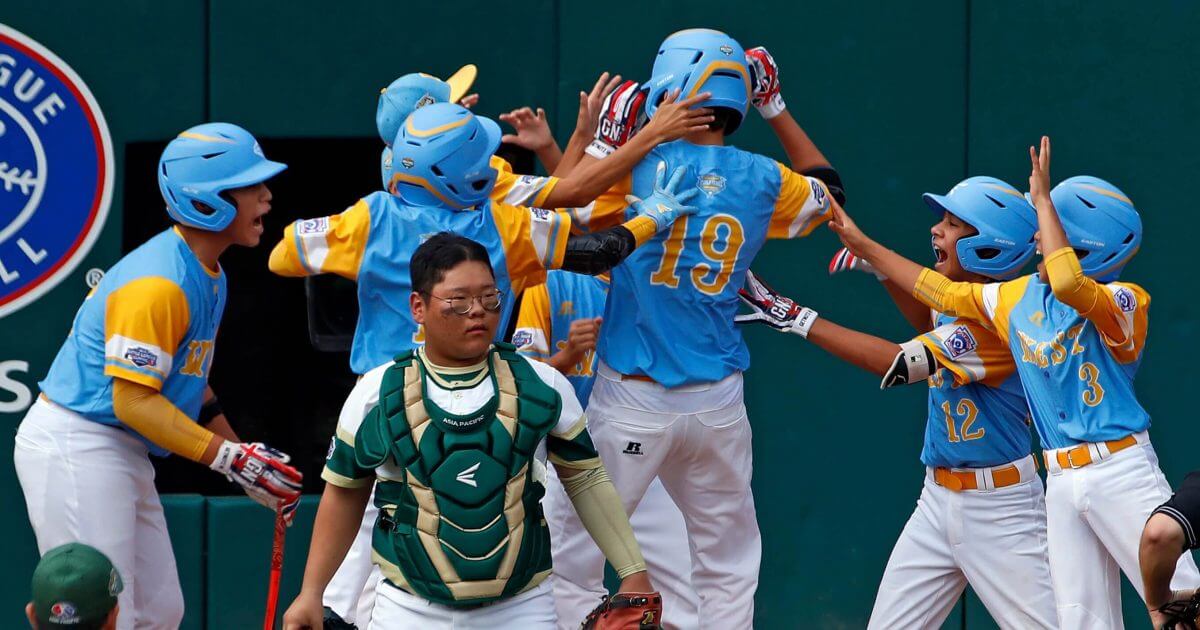 South Korea catcher Gi Jeong Kim, walks to the mound as Honolulu, Hawaii's Mana Lau Kong (19) is greeted by teammates after hitting the first pitch of the game for a solo home run in the first inning of the Little League World Series Championship in South Williamsport, Pa., Sunday, Aug. 26, 2018.