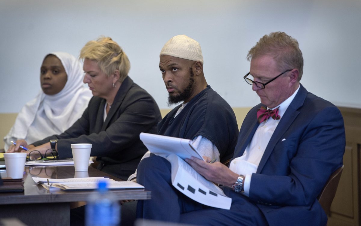 Jany Leveille, from left, with her attorney Kelly Golightley, and Siraj Ibn Wahhaj with attorney Tom Clark listen to the prosecutor during a hearing on a motion to dismiss in the Taos County Courthouse.